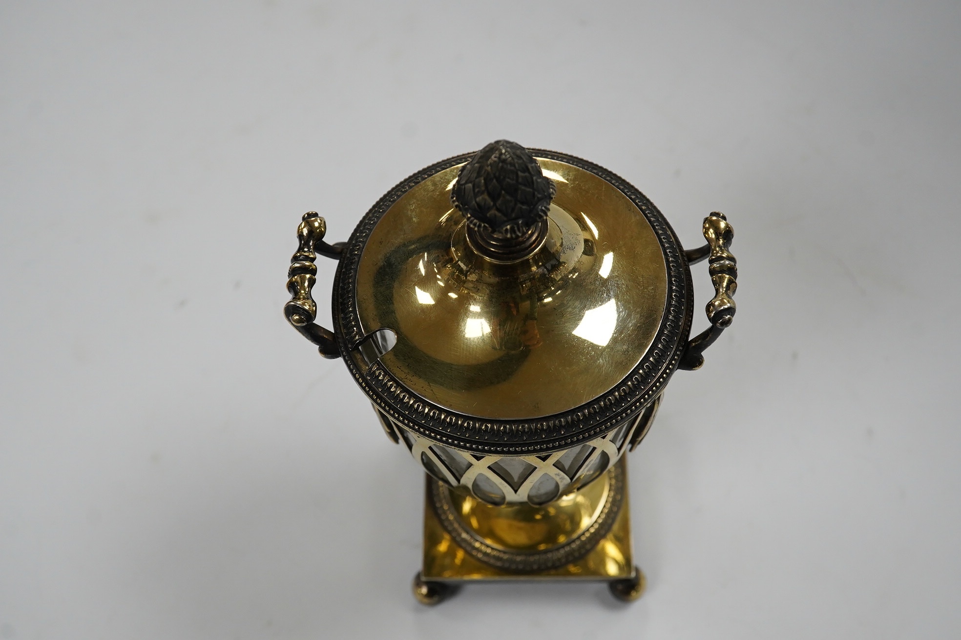 A George V pierced silver gilt two handled sugar vase and cover, by Holland, Aldwinckle & Slater, London, 1912, with clear glass liner, height 17.7cm, 9.7oz. Condition - fair to good